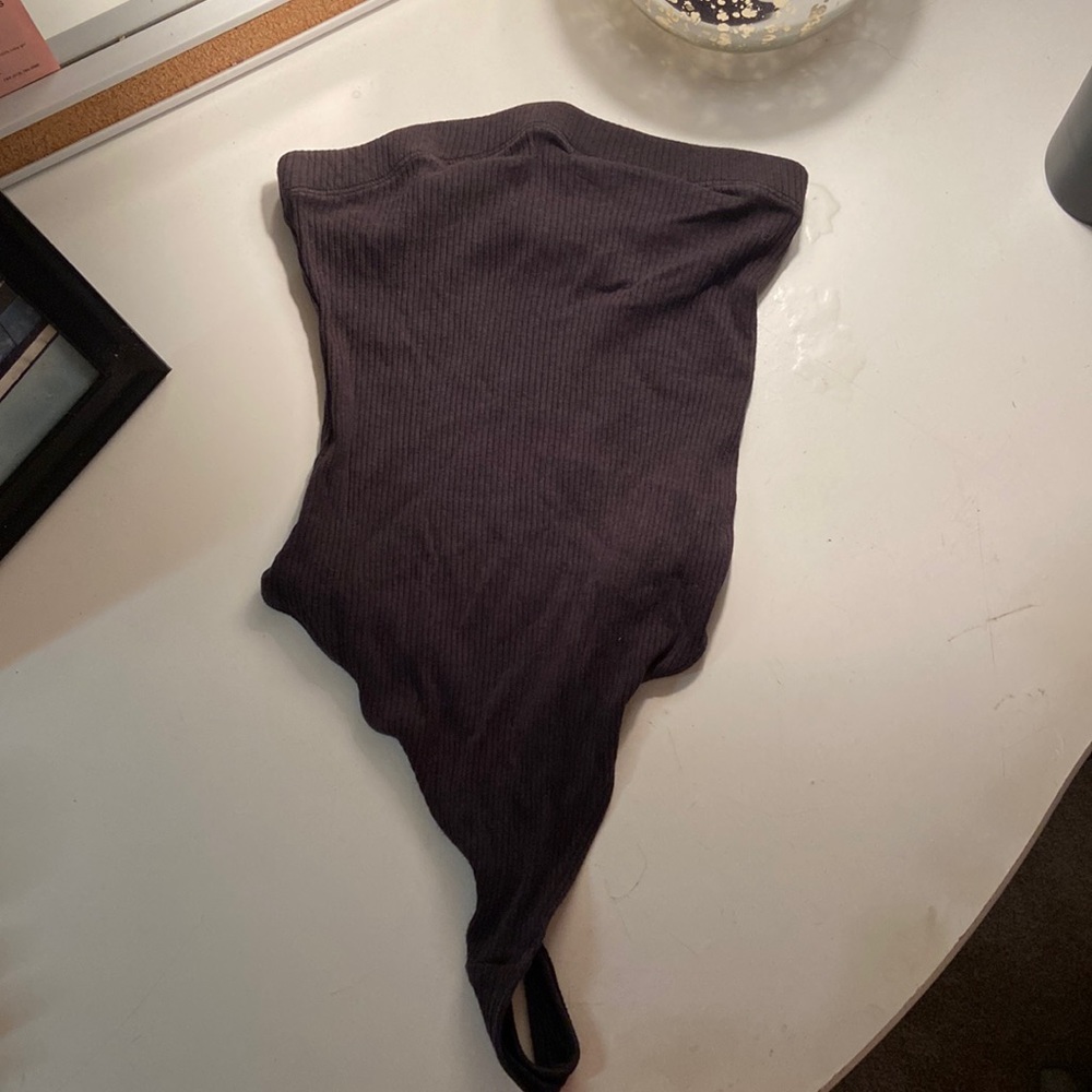 Out from under black strapless bodysuit